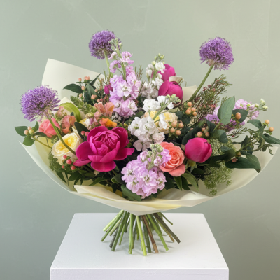 Garden Bouquet - A lush handtied bouquet with peonies, alliums, roses and cottage garden flowers in pink and lilac tones.