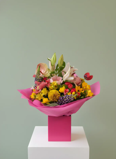 Bright Wishes - A joyful hand-tied bouquet bursting with vibrant colour, fresh textures, and seasonal charm. Expertly arranged in a lively blend of cheerful shades and presented in stylish contemporary wrapping, this design creates a striking and uplifting gift for any occasion. Full of warmth, energy, and natural beauty, it is perfect for birthdays, celebrations, congratulations, thank-you gifts, or simply bringing a smile to someone's day. A delightful arrangement that makes a memorable and heartfelt gestu
