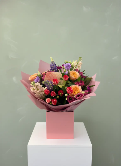 Sweet Harmony - A charming hand-tied bouquet beautifully presented in soft pink wrapping, bringing together a delightful mix of pastel shades, vibrant highlights, and fresh seasonal textures. Carefully arranged to create a balanced and elegant display, this bouquet radiates warmth, joy, and sophistication. Perfect for birthdays, anniversaries, thank-you gifts, celebrations, or simply letting someone know they are special, it offers a thoughtful and uplifting gesture that is sure to brighten any occasion. Its contemporary presentation and cheerful colour palette make it a memorable floral gift.