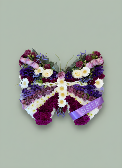 Bespoke butterfly - A beautifully handcrafted butterfly tribute, created with fresh seasonal flowers to celebrate the life of a loved one. Shown in elegant purple, lilac and white tones, this design can be made in any colour combination to reflect your personal preference. A meaningful and graceful funeral tribute, finished with a personalised ribbon if required.